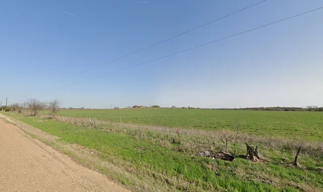 a view of a field with an ocean beach