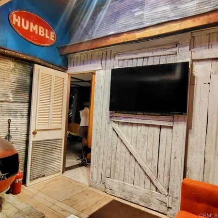 a view of a hardwood floor and an entryway