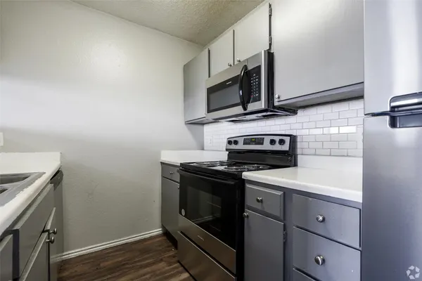 a kitchen with a stove microwave and sink
