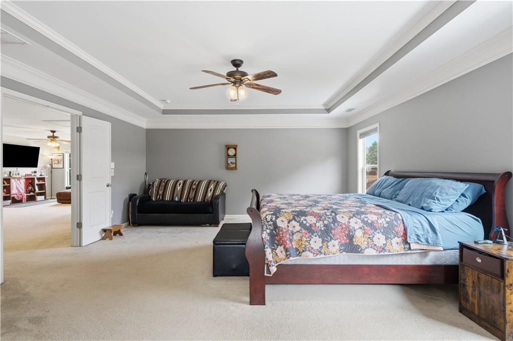 5825 Willow Oak Pass Cumming, GA 30040 - Photo 28 of 55 a bedroom with a bed and a chandelier
