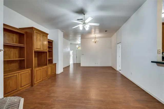 a view of an empty room with closet and a window