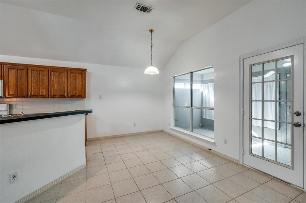 6812 Cold Water Canyon Road Fort Worth, TX 76132 - Photo 5 of 12 a view of an empty room with window and cabinet