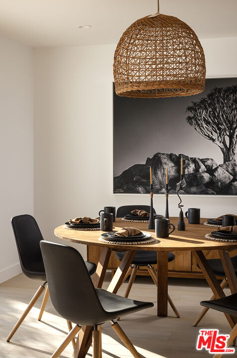 20374 Seaboard Road Malibu, CA 90265 - Photo 11 of 43 a table chair sitting in a kitchen next to a stove