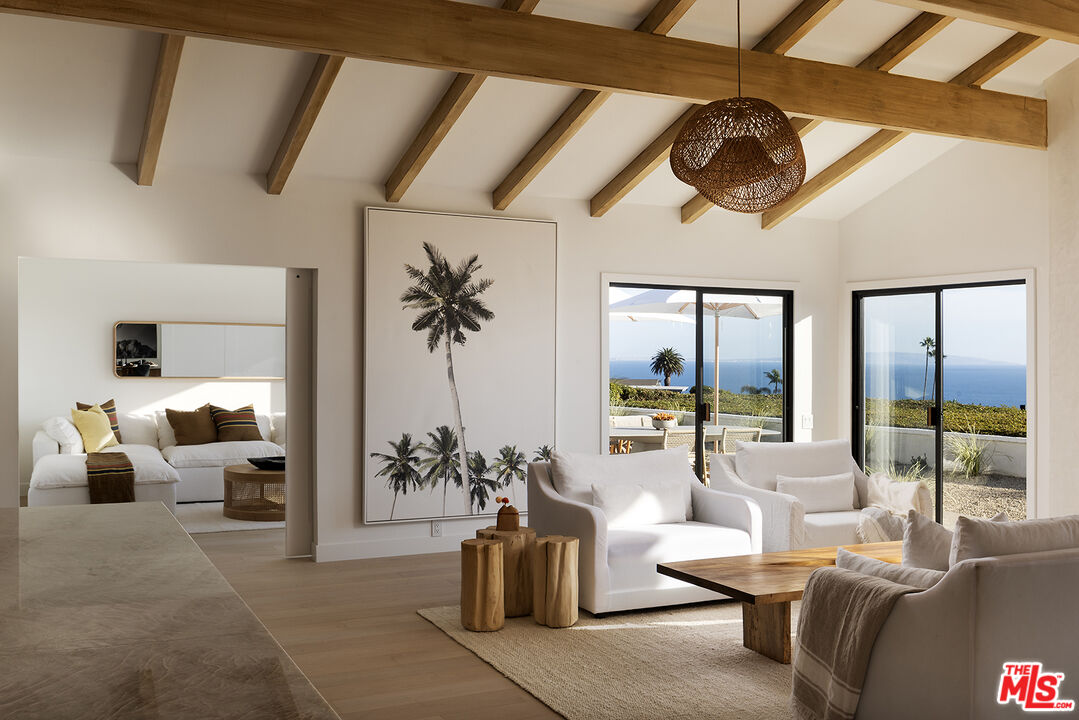 20374 Seaboard Road Malibu, CA 90265 - Photo 12 of 43 a living room with furniture ceiling fan and a large window