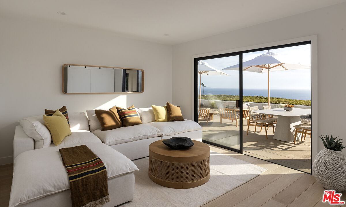 20374 Seaboard Road Malibu, CA 90265 - Photo 14 of 43 a living room with furniture and a floor to ceiling window