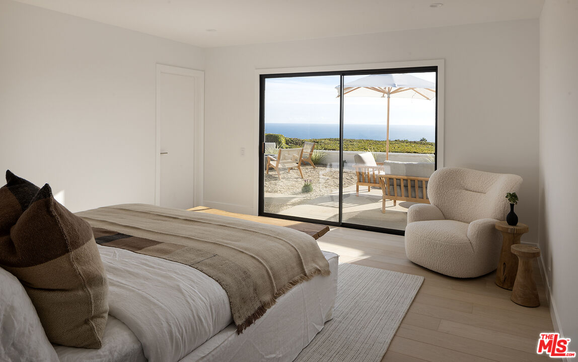 20374 Seaboard Road Malibu, CA 90265 - Photo 16 of 43 a bedroom with a bed and a large window