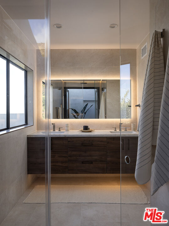 20374 Seaboard Road Malibu, CA 90265 - Photo 19 of 43 a bathroom with a sink vanity and a mirror