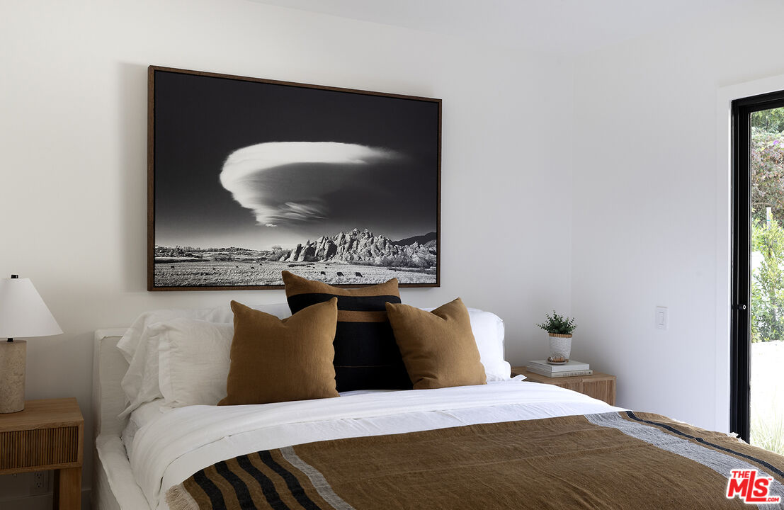 20374 Seaboard Road Malibu, CA 90265 - Photo 22 of 43 a bedroom with a bed and a mirror