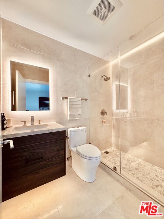 20374 Seaboard Road Malibu, CA 90265 - Photo 23 of 43 a bathroom with a sink toilet a mirror and shower