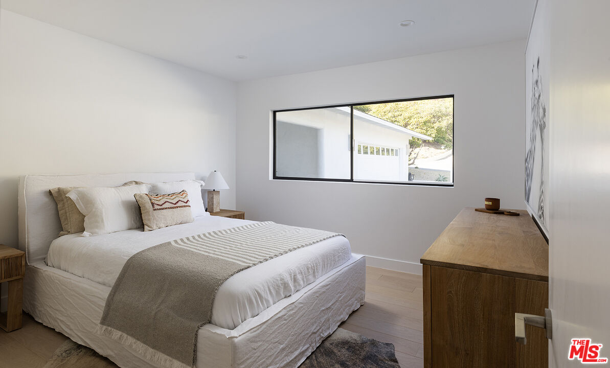 20374 Seaboard Road Malibu, CA 90265 - Photo 30 of 43 a bedroom with a bed and a window