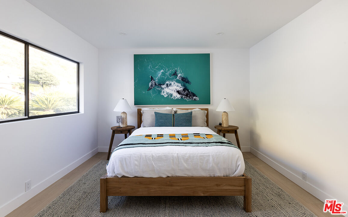 20374 Seaboard Road Malibu, CA 90265 - Photo 31 of 43 a bedroom with a bed a painting and a window