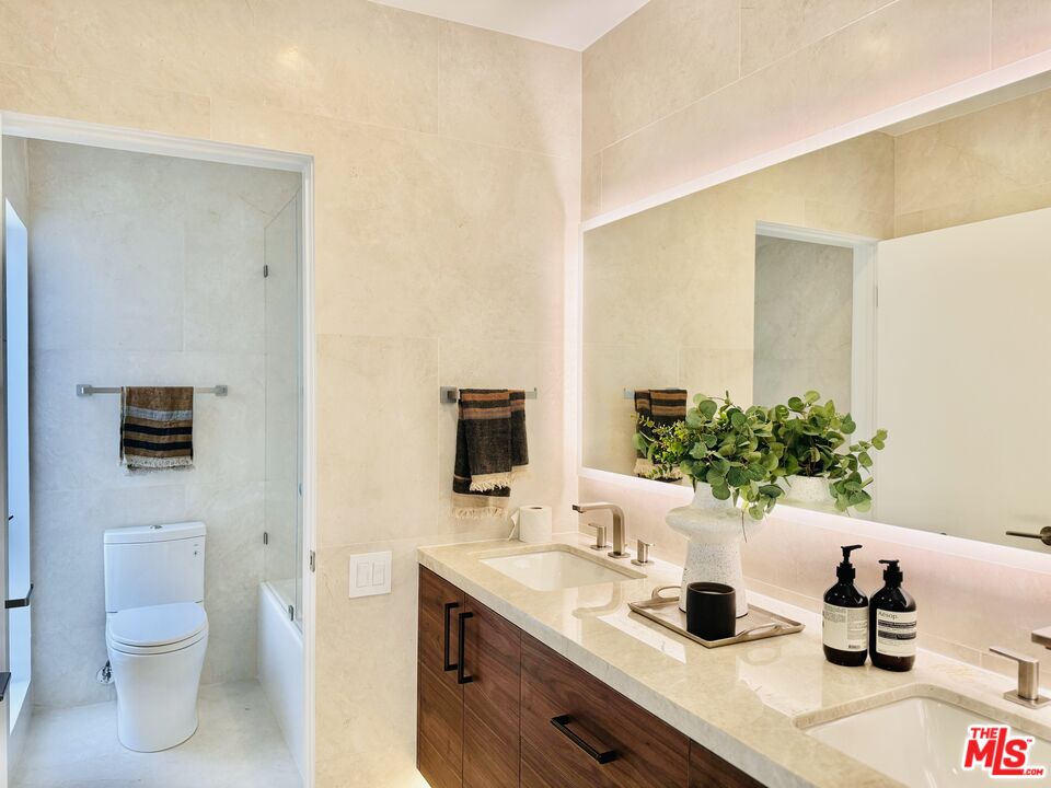 20374 Seaboard Road Malibu, CA 90265 - Photo 32 of 43 a bathroom with a toilet a sink and mirror