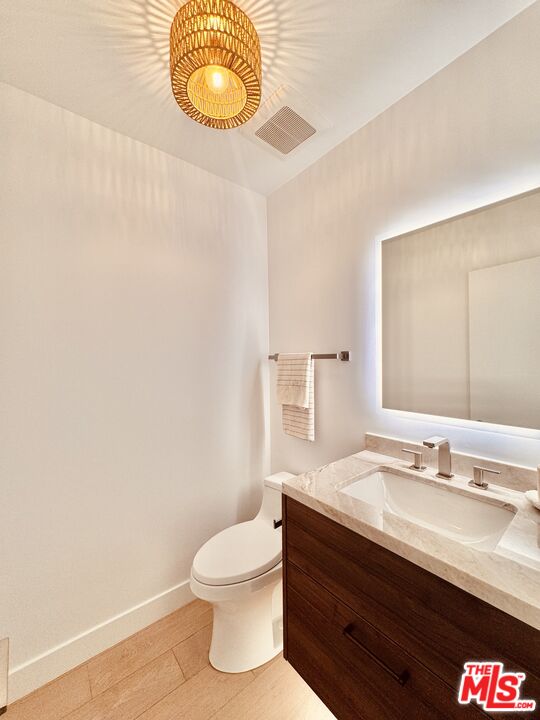 20374 Seaboard Road Malibu, CA 90265 - Photo 35 of 43 a bathroom with a sink mirror vanity and toilet