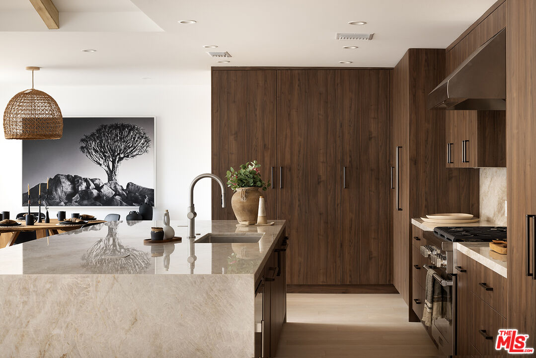 20374 Seaboard Road Malibu, CA 90265 - Photo 6 of 43 a kitchen with stainless steel appliances granite countertop a stove top oven a sink and dishwasher