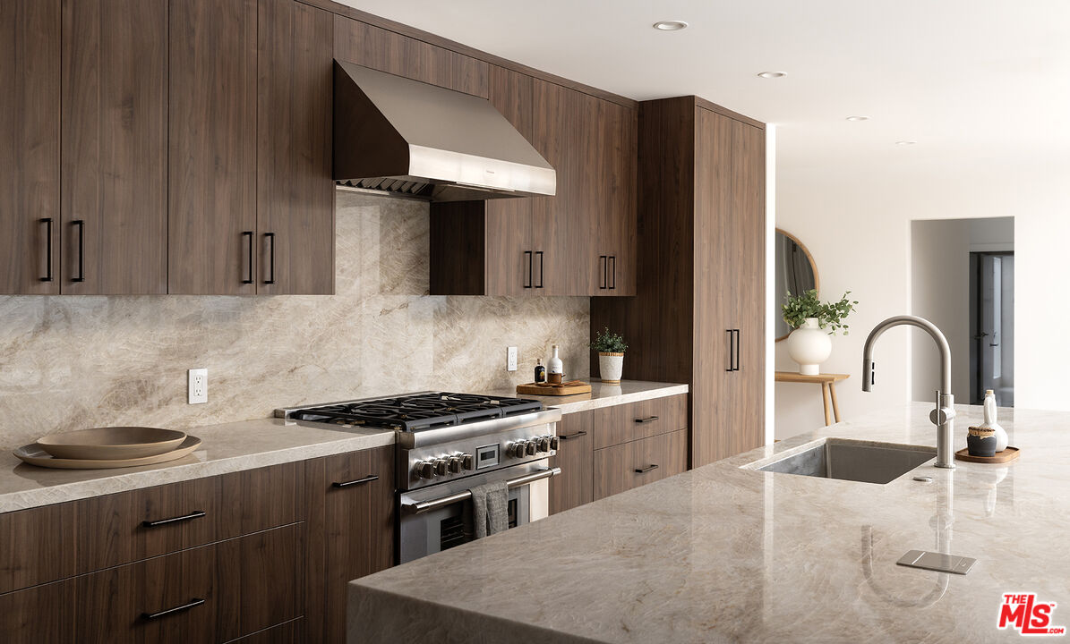 20374 Seaboard Road Malibu, CA 90265 - Photo 8 of 43 a kitchen with stainless steel appliances a sink a stove and cabinets