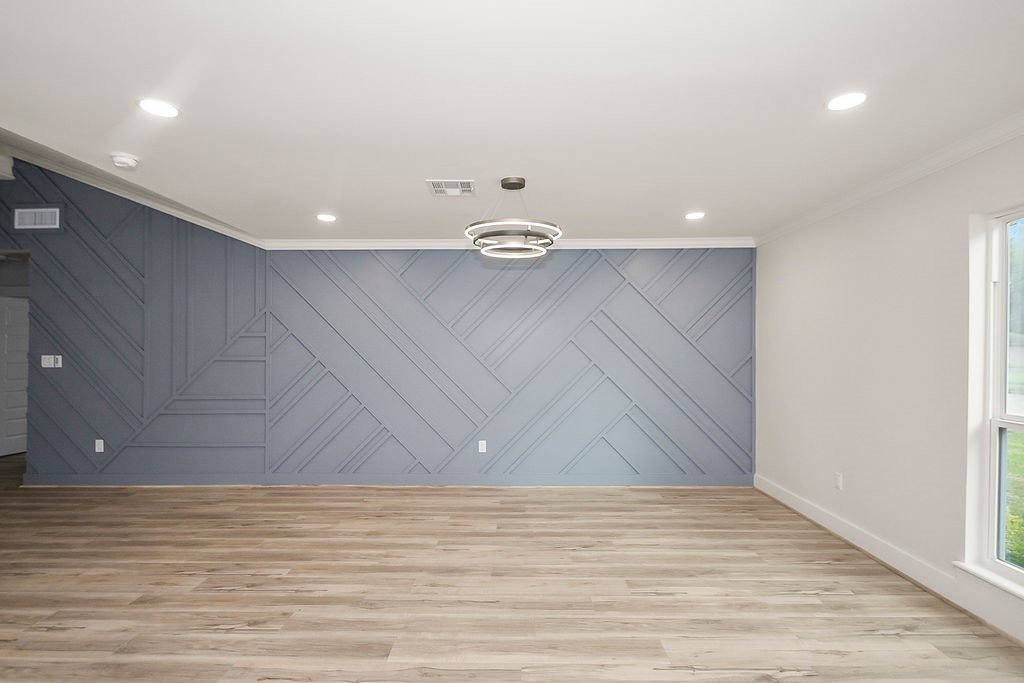 6106 Rutherglenn Drive Houston, TX 77096 - Photo 8 of 41 Another angle of the spacious living room showcasing designer accent walls and updated flooring.