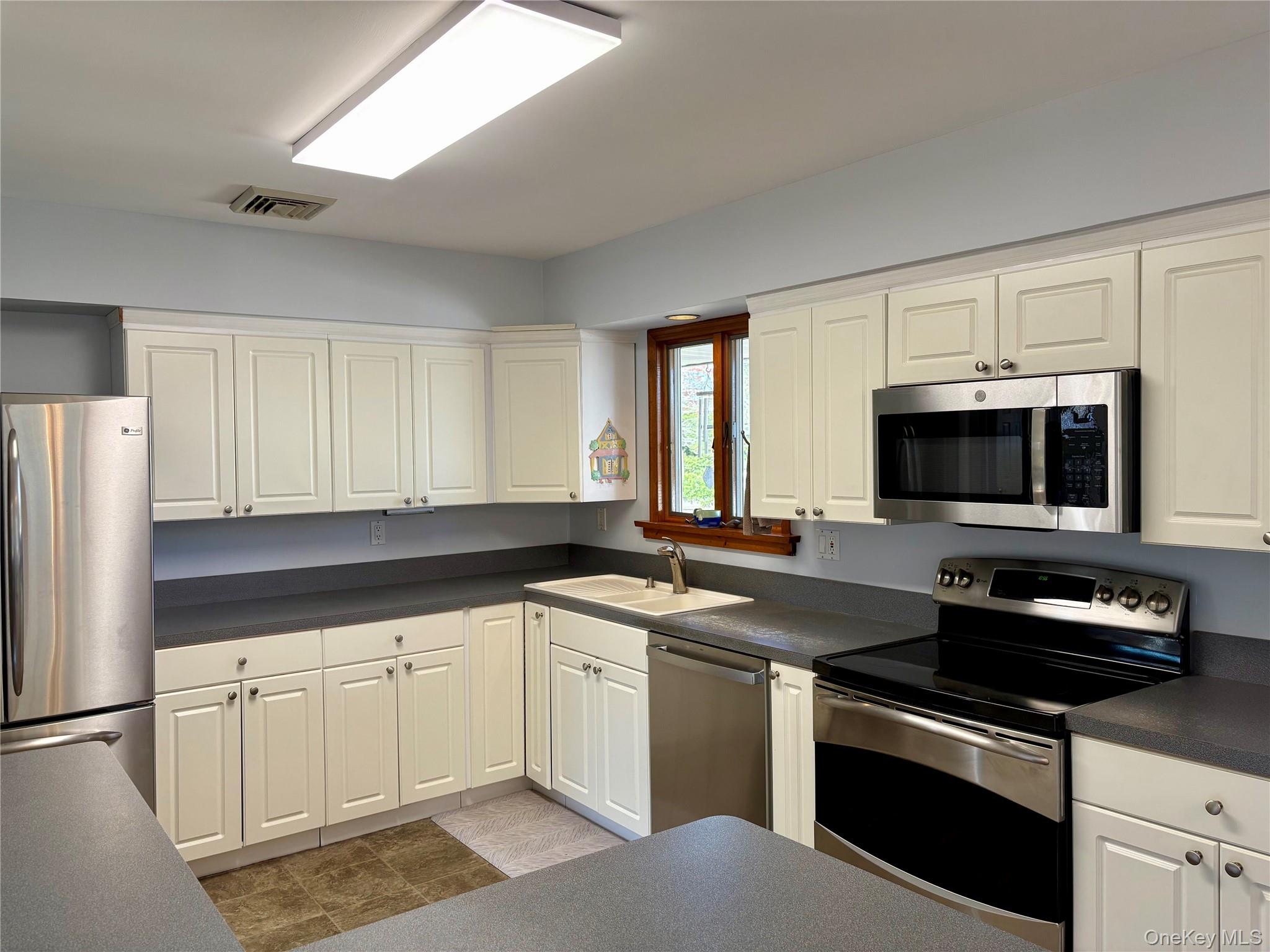 223 Timber Point Road East Islip, NY 11730 - Photo 12 of 47 a kitchen with a sink stove and microwave