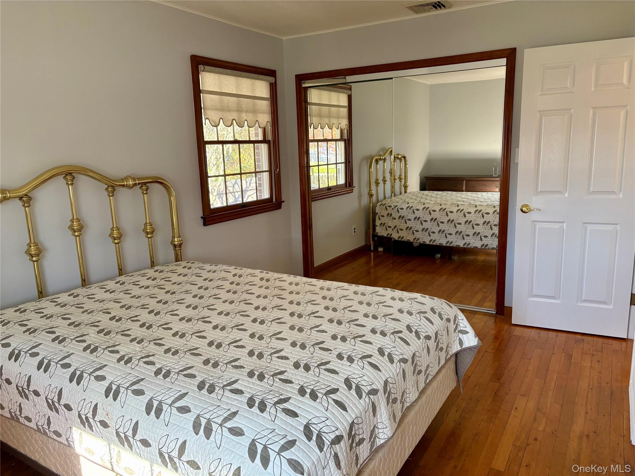 223 Timber Point Road East Islip, NY 11730 - Photo 22 of 47 a bedroom with a bed next to a window