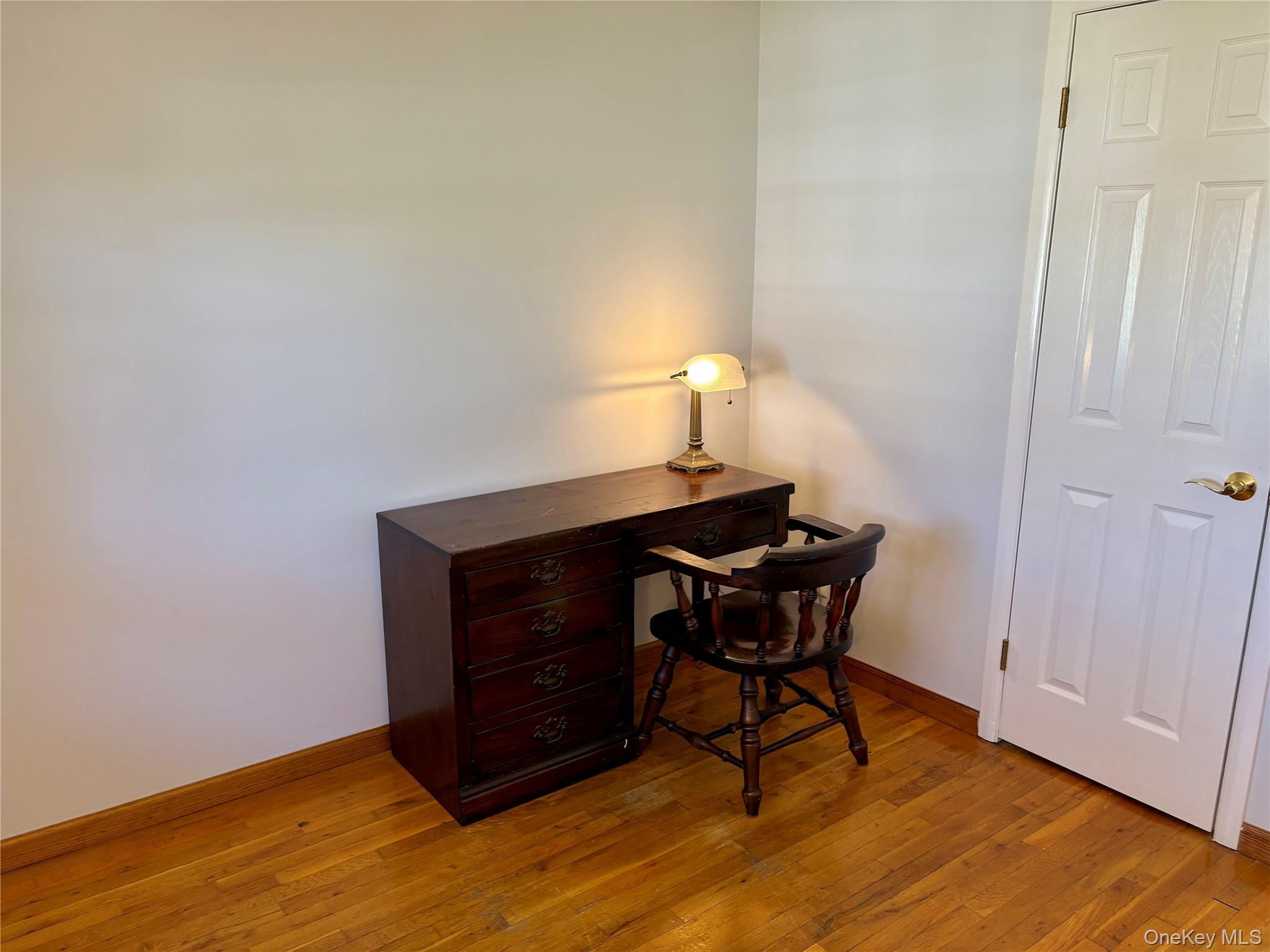 223 Timber Point Road East Islip, NY 11730 - Photo 23 of 47 a view of a workspace with furniture and wooden floor