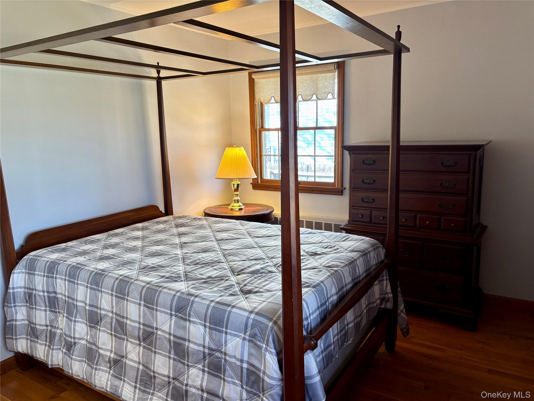 223 Timber Point Road East Islip, NY 11730 - Photo 25 of 47 a bed sitting in a bedroom next to a window