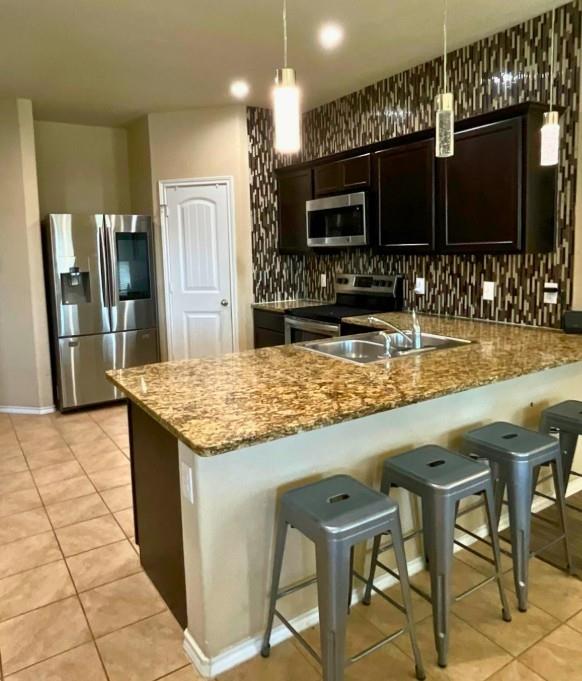 300 Preakness Lane Ponder, TX 76259 - Photo 2 of 5 a kitchen with stainless steel appliances kitchen island granite countertop a table and chairs in it