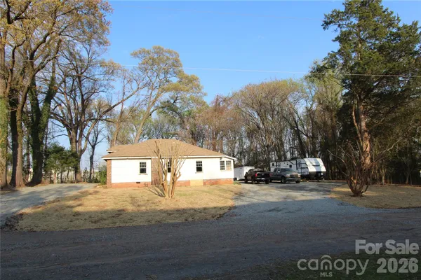 a view of big yard with large trees