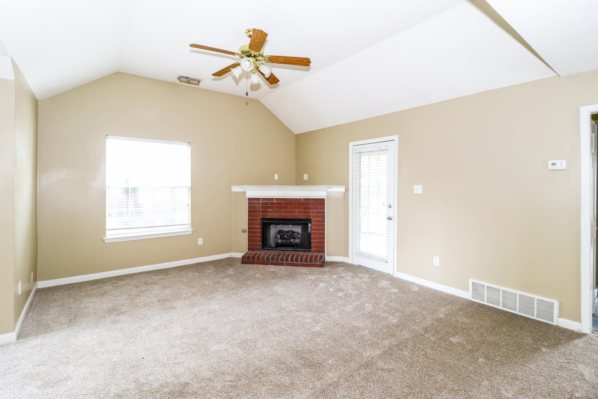 10097 Cross Ridge Road Cordova, TN 38018 - Photo 3 of 17 a view of an empty room with a fireplace and a window