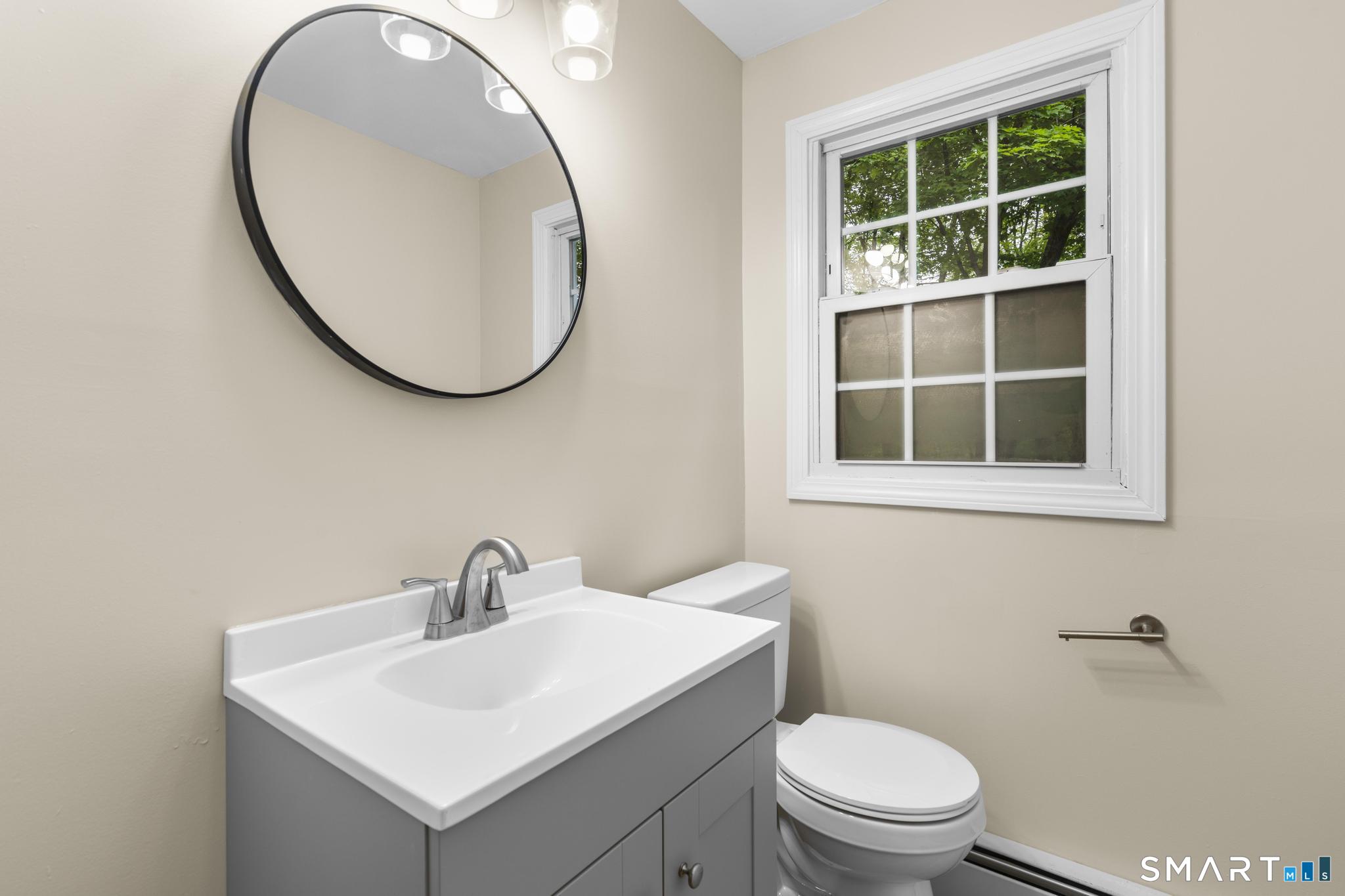 7 Sycamore Terrace Windham, CT 06280 - Photo 18 of 40 a bathroom with a toilet a sink and a mirror
