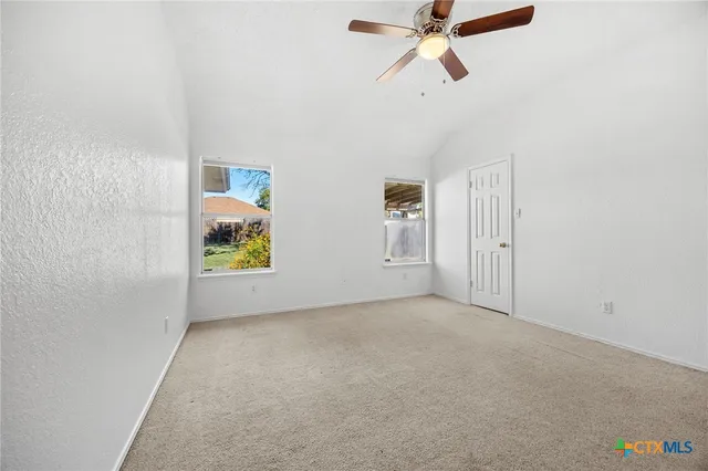 an empty room with windows and closet