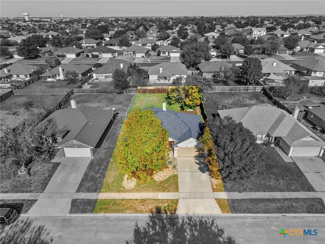 an aerial view of residential houses with outdoor space