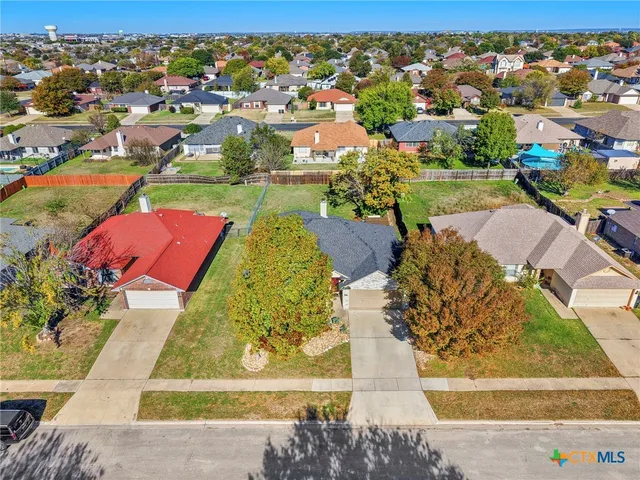 an aerial view of residential houses with outdoor space and street view