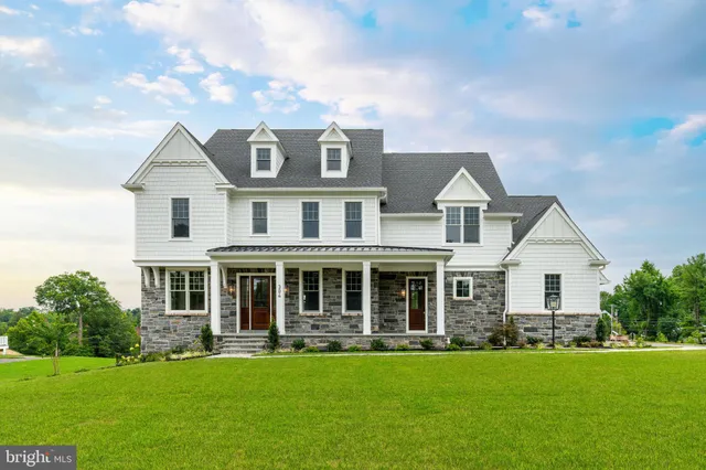 a front view of a house with a garden and porch