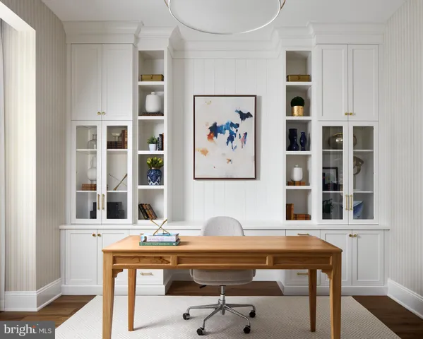 a view of a dining room with a table and chairs