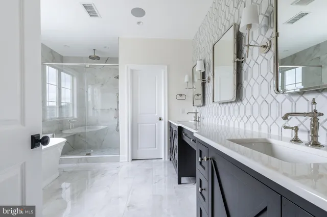 a bathroom with a granite countertop sink a mirror and a shower