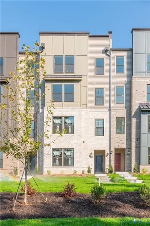 a front view of a building with a yard