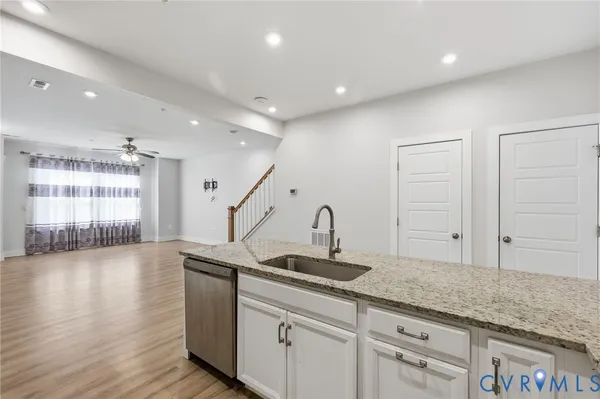 a kitchen with sink cabinets and wooden floor