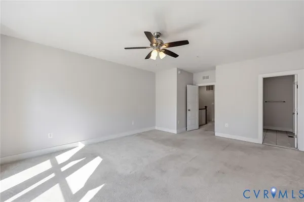 a view of empty room with ceiling fan