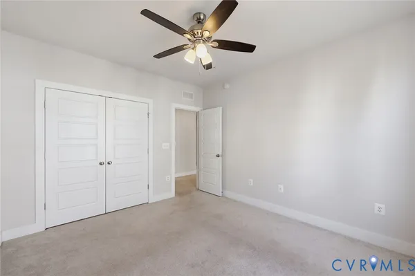 an empty room with a ceiling fan
