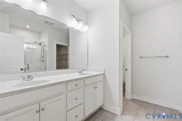 a spacious bathroom with a double vanity sink mirror and