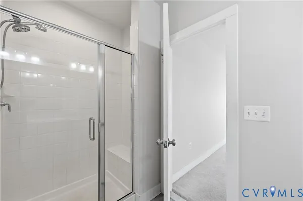 a bathroom with a glass shower door