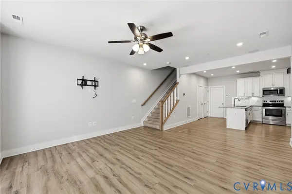 a view of an empty room with a ceiling fan