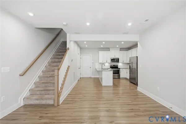 a view of kitchen with wooden floor and electronic appliances