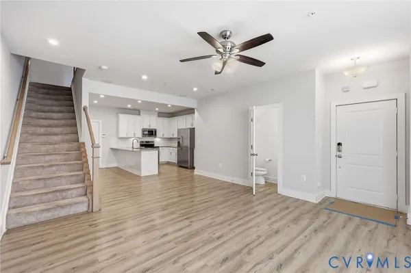 a view of kitchen and hall with wooden floor