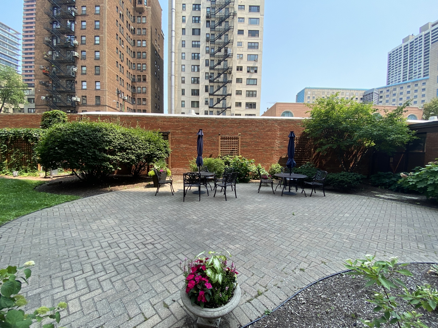 2909 North Sheridan Road, Unit 805 Chicago, IL 60657 - Photo 29 of 39 a view of a patio with table and chairs and potted plants