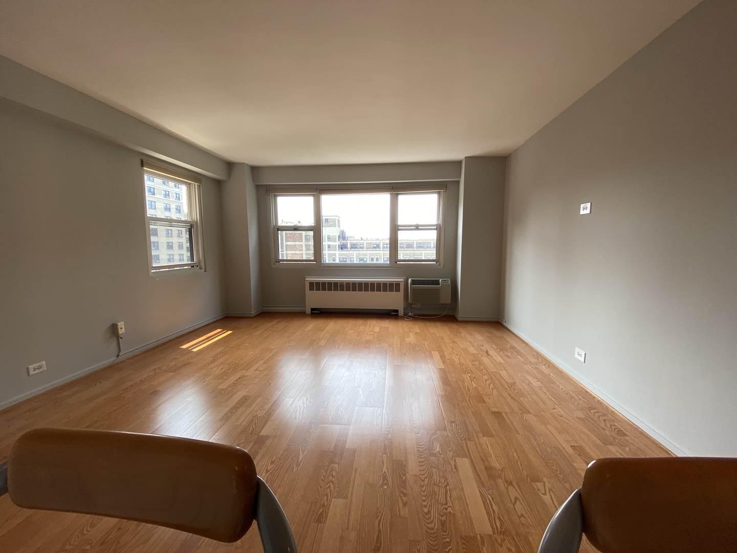 2909 North Sheridan Road, Unit 805 Chicago, IL 60657 - Photo 8 of 39 wooden floor in an empty room with a window