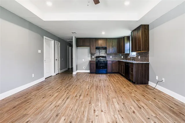 a kitchen with stainless steel appliances granite countertop a stove and refrigerator