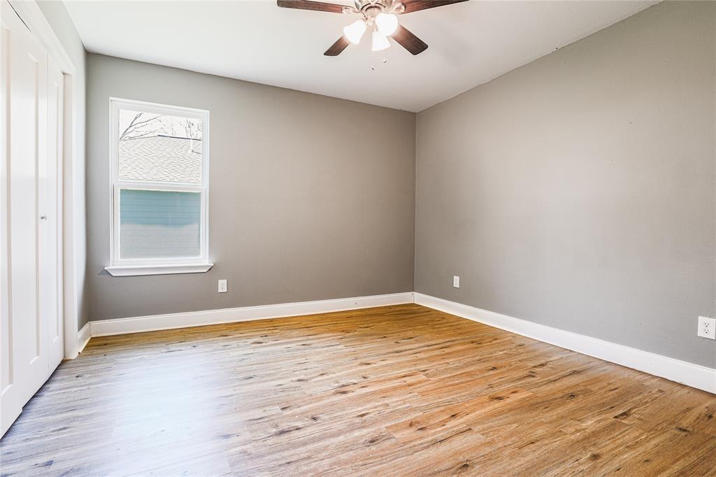 900 Cedar Street Commerce, TX 75428 - Photo 8 of 13 Empty room featuring baseboards, ceiling fan, and light wood-type flooring