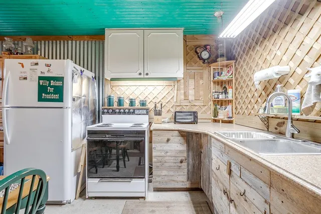 a kitchen with a sink window and cabinets