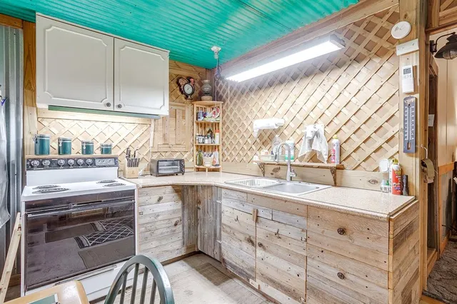 a dining room with furniture a kitchen a table and chairs