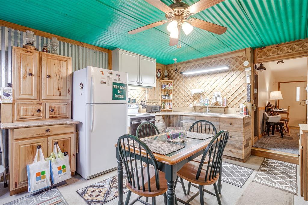 436 Luke Road Springtown, TX 76082 - Photo 20 of 39 a dining room with furniture a kitchen a table and chairs